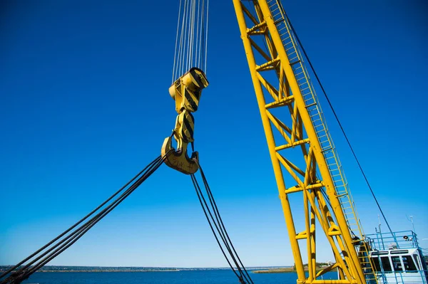 Loading in port. Floating port crane on blue sky background — Stock Photo, Image