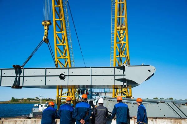 Loading in port. Floating port crane on blue sky background — Stock Photo, Image