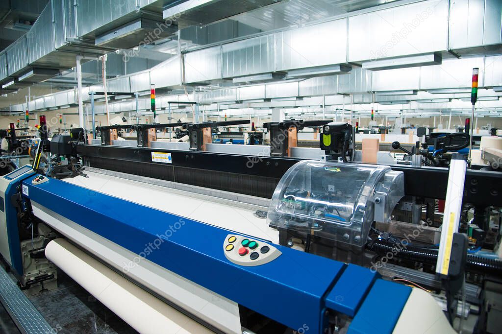 Industrial fabric production line. Weaving looms at a textile factory