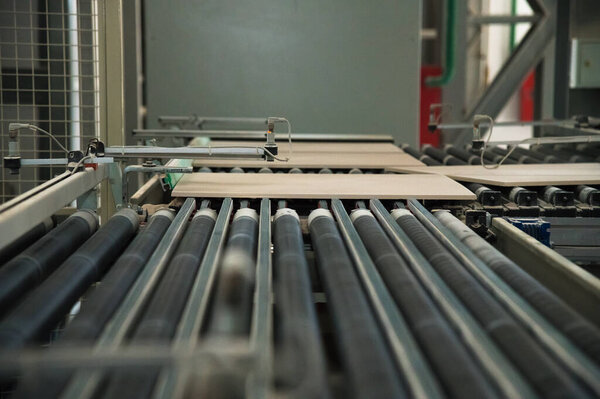 Factory for production of ceramic tiles. Conveyor line for ceramic tile at heavy plant. The process of making ceramic tiles