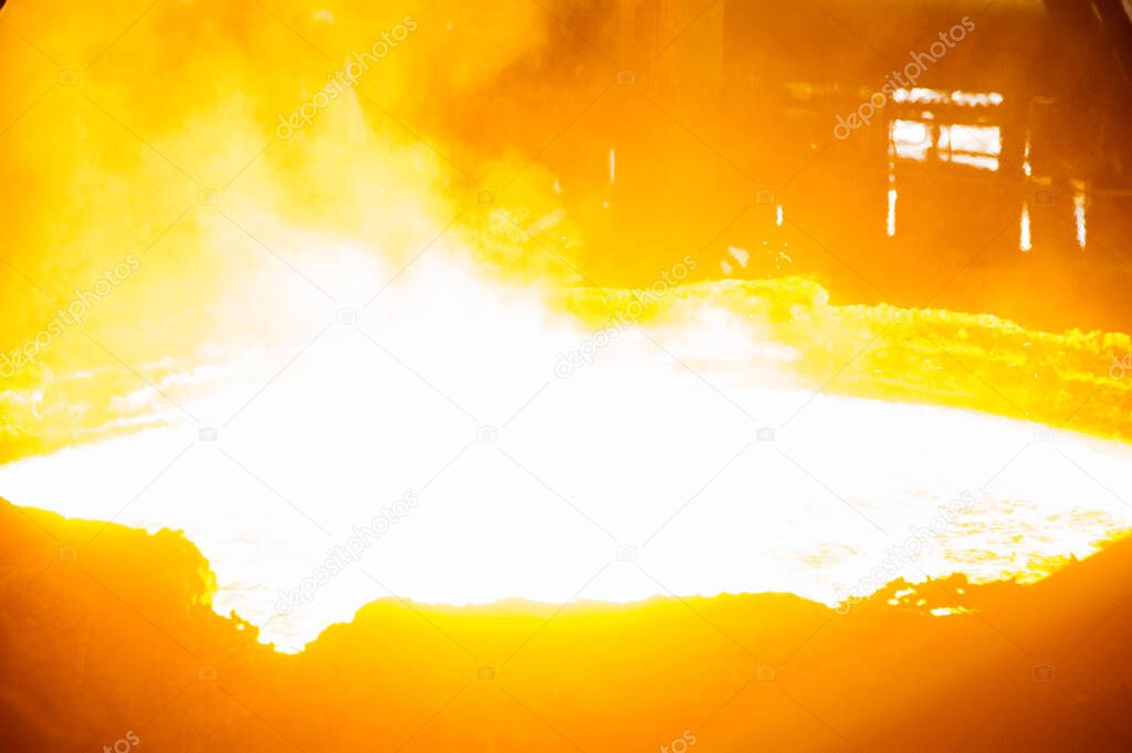 Metal structures and buildings of the old metallurgical plant inside and outside. The process of melting metal. Steelworker at work. Products of the metallurgical enterprise.