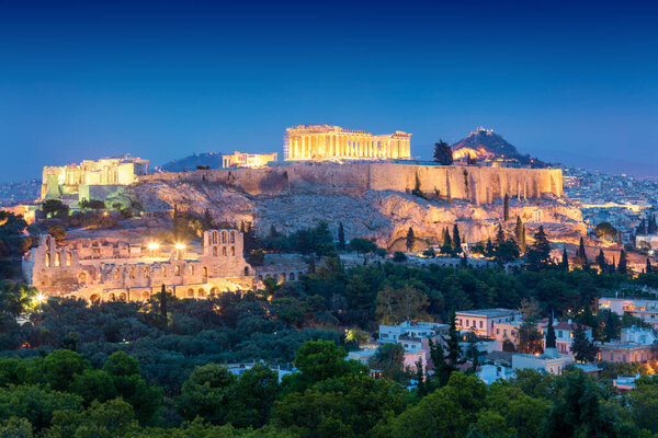 Aerial view of the Acropolis Hil  with Parthenon, above of the city skyline during evening blue hour in Athens, Greec