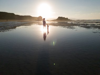 Anne ve kızı Beach su yansıması