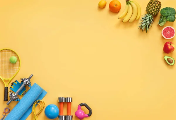 Sports equipment and organic food on yellow background. Top view. Motivation. Copy space