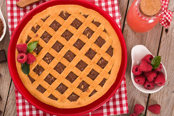 Chocolate tart on red dish.