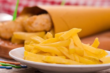 Balık ve cips kesme tahtası üzerinde.