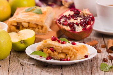 Apple strudel beyaz çanak üzerinde narlı.