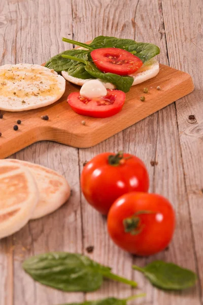 Tigella bread with spinach and tomatoes.