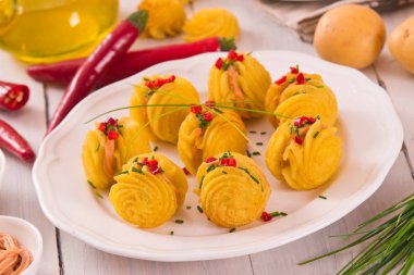 Düşes patates sandviç beyaz çanak üzerinde.