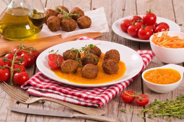 Meatballs with mashed carrots. clipart