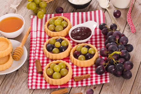 Grape tarts with jam.