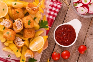 Balık ve cips kesme tahtası üzerinde.