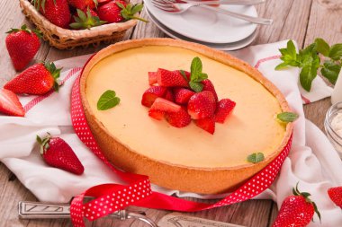 Ahşap masa üzerinde nane ile Çilek cheesecake.