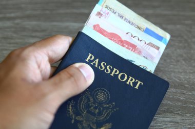 Amerikan pasaportu ve açık gri ahşap arka planı üzerinde yabancı para birimi