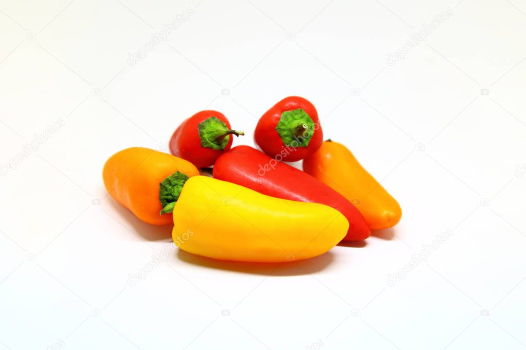 sweet multicolored peppers over a white background