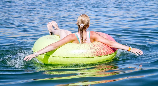 Woman on an inflatable mattress on the water in the sea