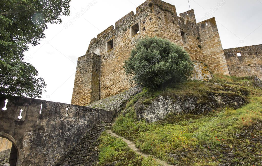 a wall with cross-shaped shooting holes in the old convent of temples in Tomar, Portugal