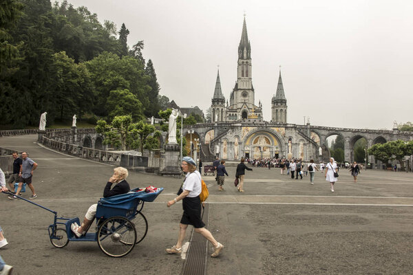 Lourdes, France June 24, 2019: Volunteers helping the sick get t