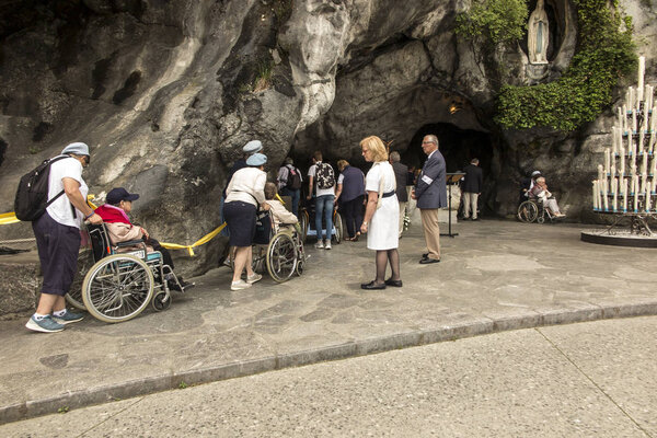 Lourdes, France June 24, 2019: Volunteers helping the sick get t
