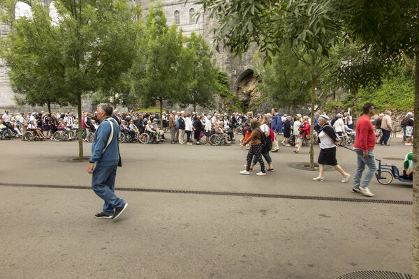 Lourdes, France June 24, 2019: Volunteers helping the sick get t