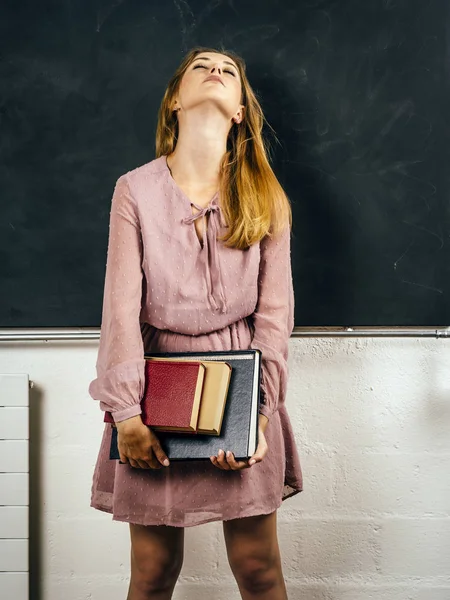 Photo Frustrated Young Student Holding Books Front Blackboard Class — Stock Photo, Image