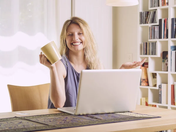 Happy at home with her laptop — Stock Photo, Image