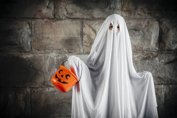 Bed sheet ghost with pumpkin bucket for Halloween — Stock Photo, Image