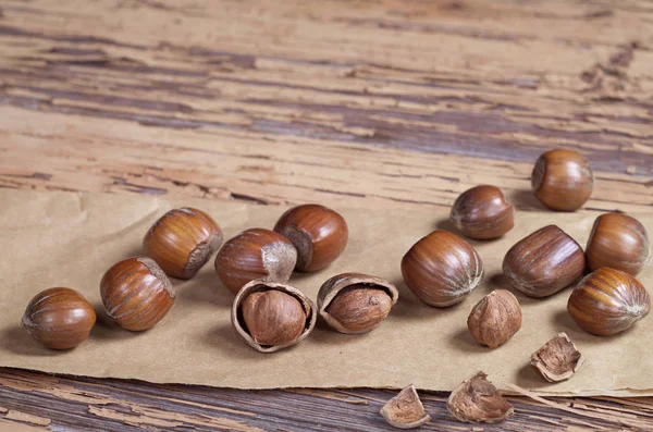 Close Hazelnut Whole Kernels Nut Shell Paper Located Old Wooden — Stock Photo, Image