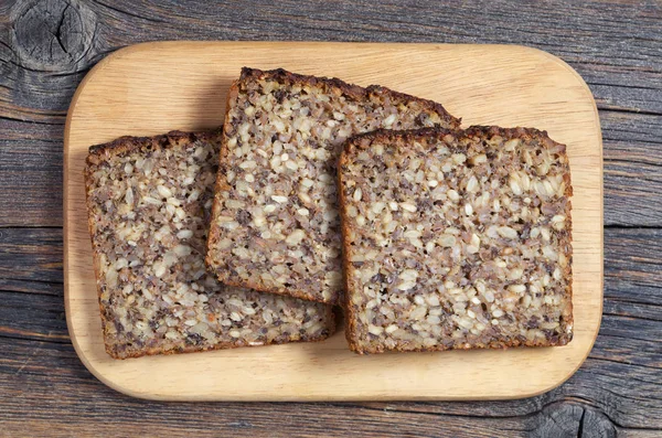 Sneetjes Brood Met Verschillende Zaden Snijplank Gelegen Aan Oude Houten — Stockfoto