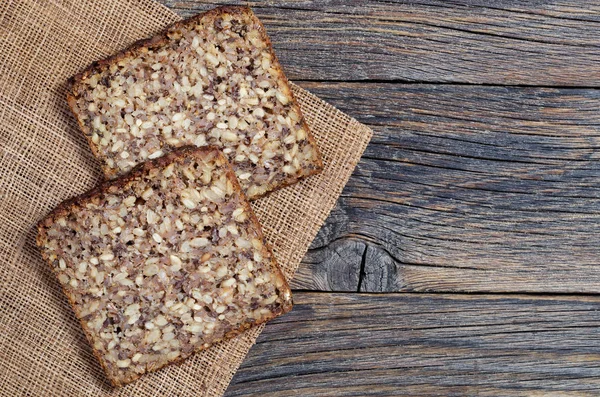 Twee Sneetjes Brood Met Verschillende Zaden Oude Houten Tafel Bovenaanzicht — Stockfoto