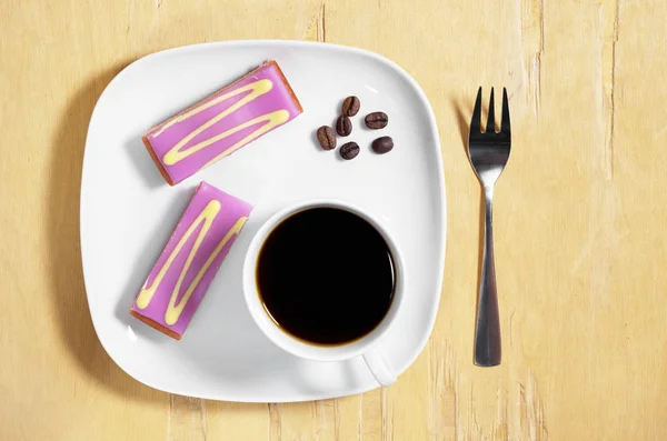 Coffee and cake with purple fondant icing