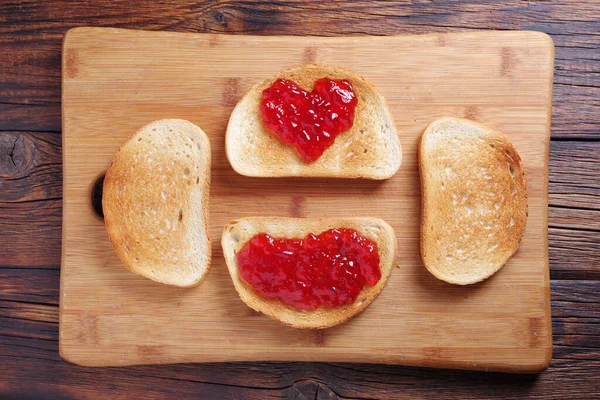 烤面包 在木桌上的切菜板上有草莓果酱 — 图库照片