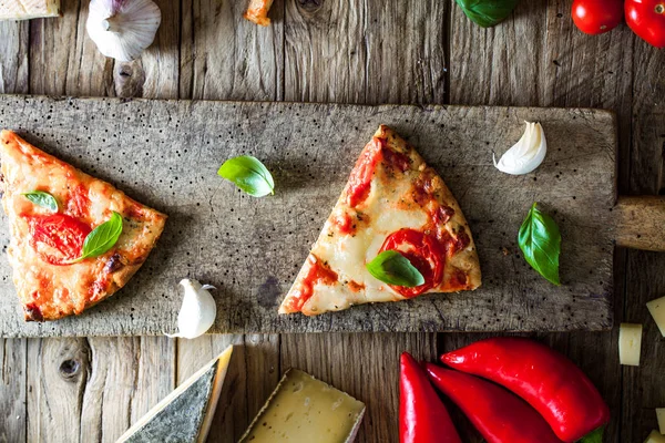 Pizza sobre madera con ingredientes — Foto de Stock