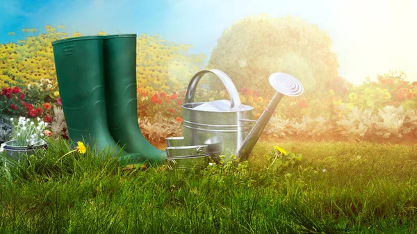 Spring garden. Boots and gardening tools in green grass. — Stock Photo, Image