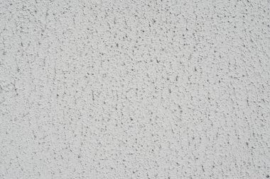 Dekoratif macunla dekore edilmiş beyaz bir duvarın dokusu.
