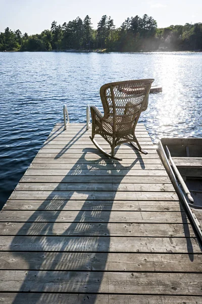 穏やかな秋の湖に椅子と木製のドック ロイヤリティフリーのストック画像