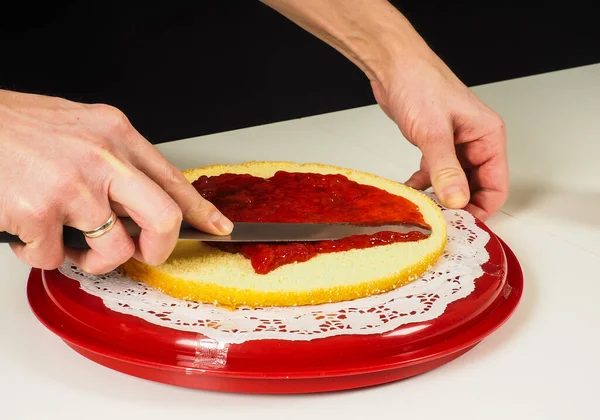 Person Die Einen Schichtkuchen Auf Einem Roten Plastikblech Herstellt — Stockfoto