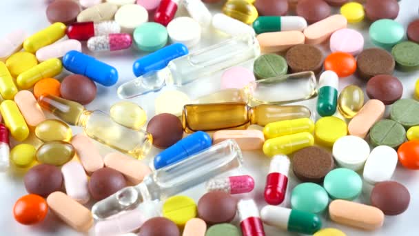 Los Comprimidos Médicos Multicolores Giran Sobre Mesa — Vídeos de Stock