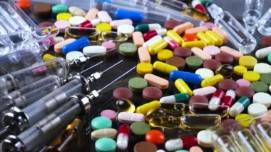 Tıbbi şırınga ve çok renkli tablet masanın üzerinde döndürmek