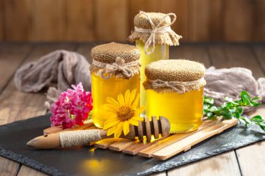 Arı balı kavanozda, çiçekli, eski arka planda..