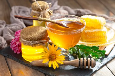 Arı balı kavanozda, çiçekli, eski arka planda..