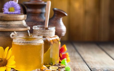 Arı balı kavanozda, çiçekli, eski arka planda..