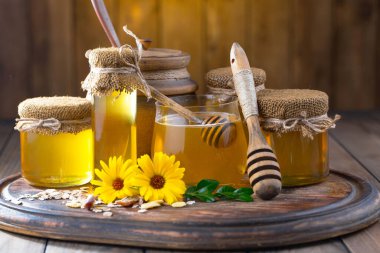 Arı balı kavanozda, çiçekli, eski arka planda..