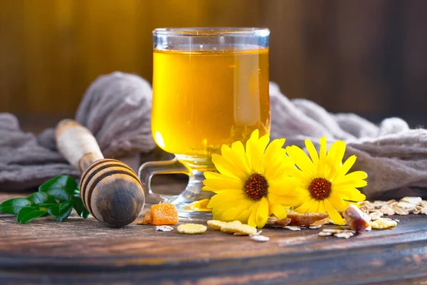 stock image Bee honey in a jar with a flower, on the old background.