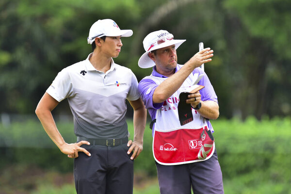 KUALA LUMPUR, MALAYSIA - October 11: Whee Kim(L) of South Korea and his caddie pictured during 1st round of CIMB CLASSIC 2018 at TPC KUALA LUMPUR, KUALA LUMPUR, MALAYSIA on October 11, 2018. (Photo by Masuti)
