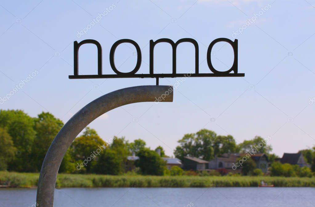 Copenhagen, Denmark - July 15, 2018: The new NOMA. Logo sign post of the Michelin star restaurant NOMA - one of the best restaurants in the world, featuring chef Rene Redzepi.