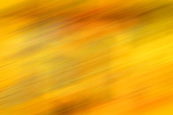 Golden blurred grunge background in yellow fall autumn colors- perfect background with space for text or image