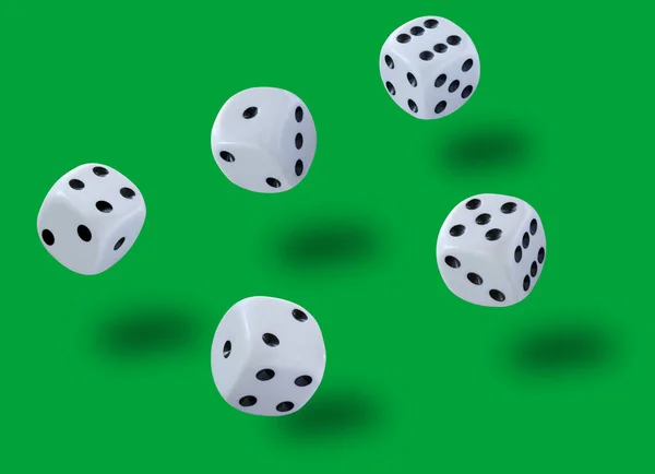 Five white dices thrown jump in a craps game, yatzy or any kind of dice game against a green background