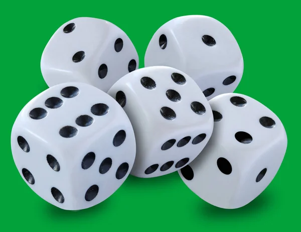 White dices in a pile thrown in a craps game, yatsy or any kind of dice game against a green background