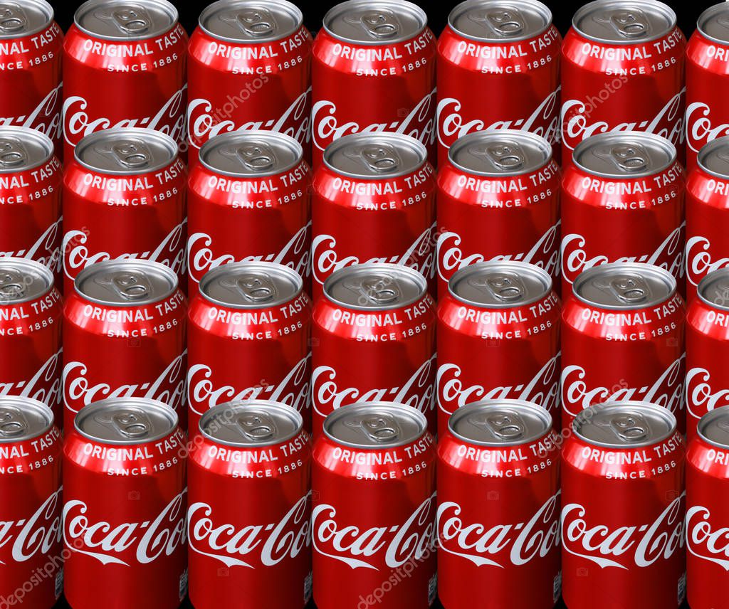 Lots of Coca Cola drink cans standing side by side in rows seen from above - The drink is produced and manufactured by The Coca-Cola Company - Image - Copenhagen, Denmark, February 13, 2019